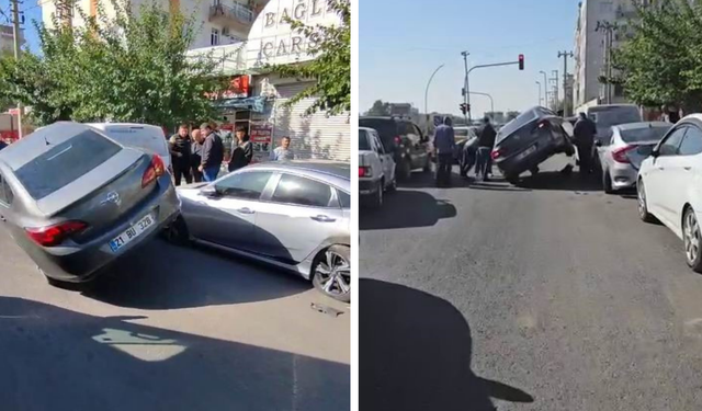 Diyarbakır’da otomobil park halindeki araçların üzerinde asılı kaldı
